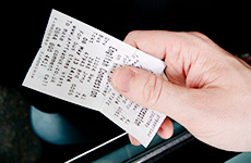 Close up of hand holding bus ticket